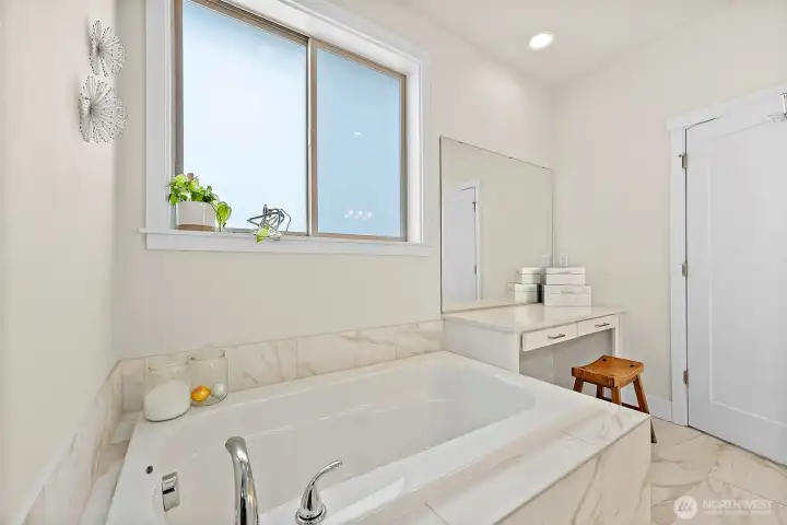 Next to the soaking tub is the built-in vanity