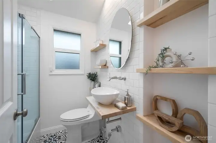 Stylish main level bathroom was transformed in 2020,  complete w/ high ceilings & skylight (not pictured)