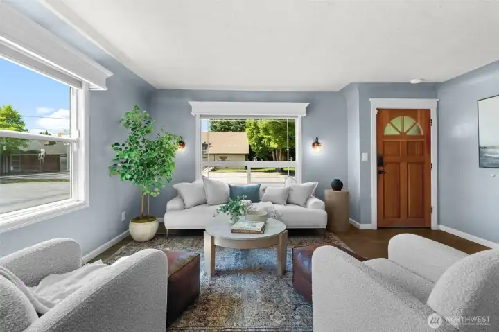 Flooded with natural light! Large windows frame the view and create a warm, inviting atmosphere in the main living space.