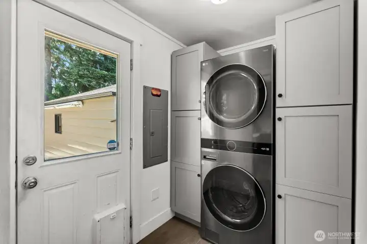 Cute, compact, and highly functional. A perfectly efficient laundry nook that makes excellent use of every single inch.