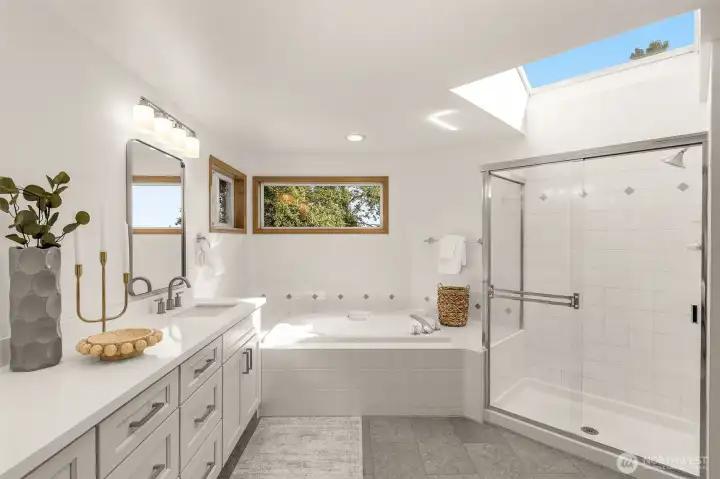 Primary bath with new quartz counters, cabinets, flooring, mirrors and lighting. Auto opening skylight too!