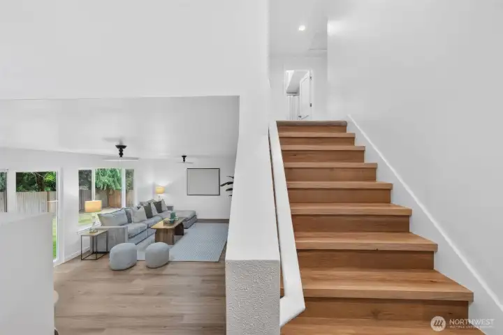 This is where the tri-level does its thing! Head downstairs to the spacious bonus room, or go up to the primary suite, two additional bedrooms, and a full bath.