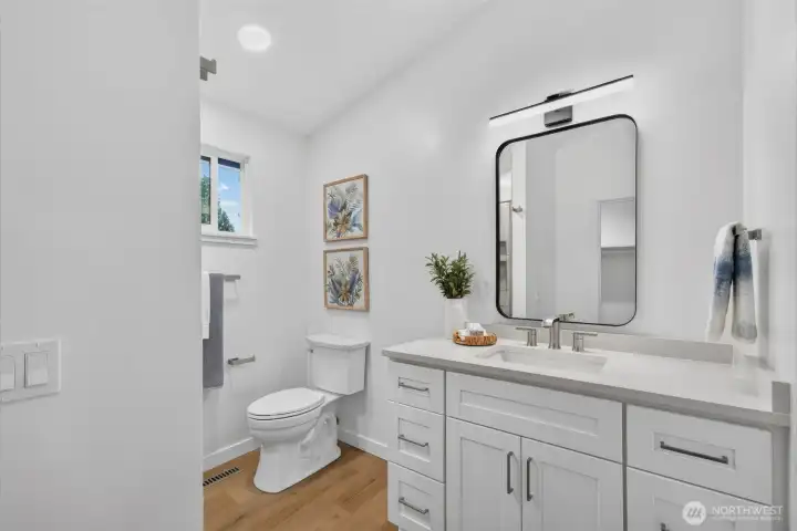 A beautifully renovated primary bath with clean, modern finishes, generous vanity storage, and a bright, fresh feel to start and end your day well.