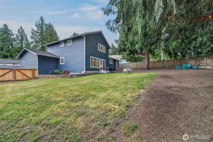 Another look at this expansive, fully fenced backyard—with lawn to play, mature trees for shade, and plenty of space to gather, garden, entertain, or simply enjoy the outdoors.