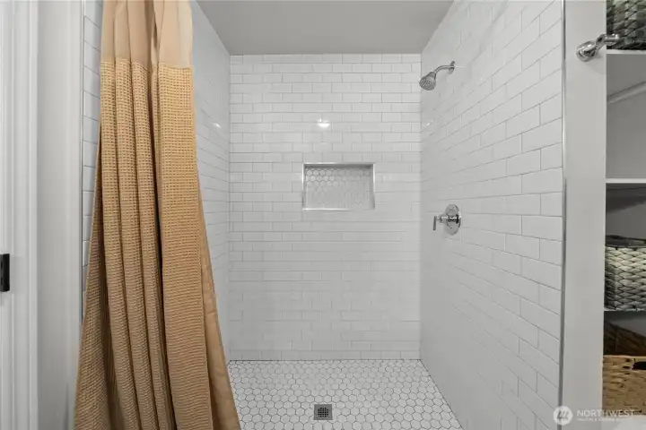 Walk in tile shower in the primary.