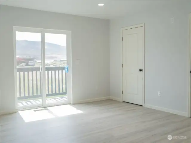 Primary with sliding glass door to back deck.