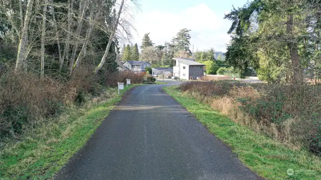 Lot is on the right and street is paved.