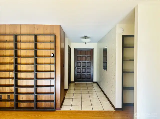 Entry area of home, showing built  in shelving in living room