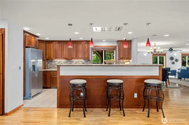 Gourmet kitchen with breakfast bar is the center of the open floor plan