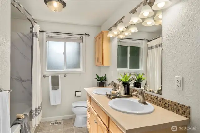 Full bath with dual vanities