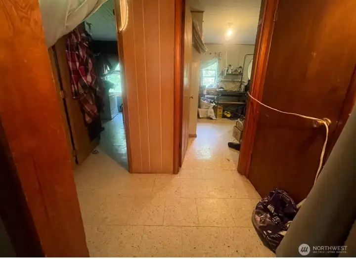 Hallway leading to master bedroom and laundry room. Bathroom is to the left.