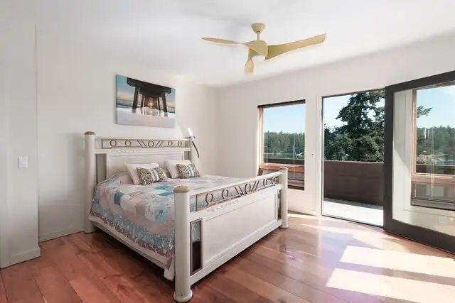 Guest bedroom in main house has an exit to outdoor deck area.