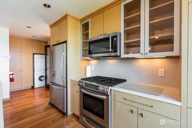 Guest apartment kitchen. Stackable washer and dryer, full size propane oven, full size refrigerator, microwave.