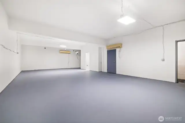 Extra large workshop space on lower level including bathroom with shower.