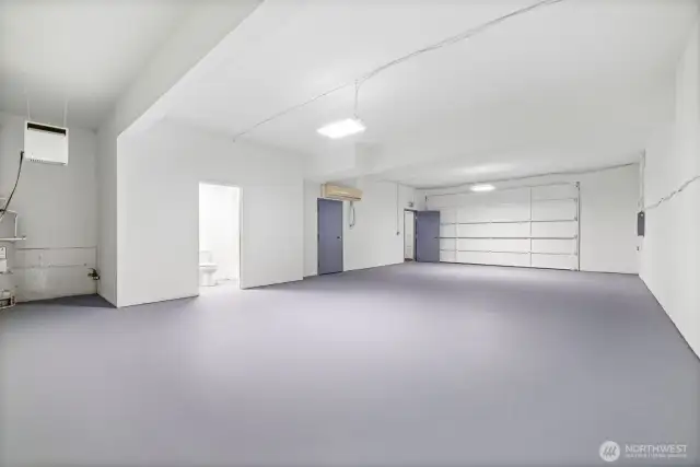 Extra large workshop space on lower level including bathroom with shower.