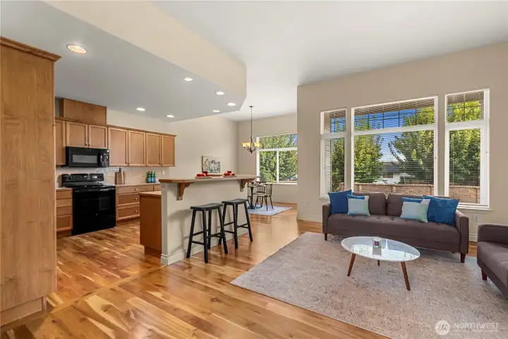Kitchen is open to living spaces with long bar with room for four bar stools.