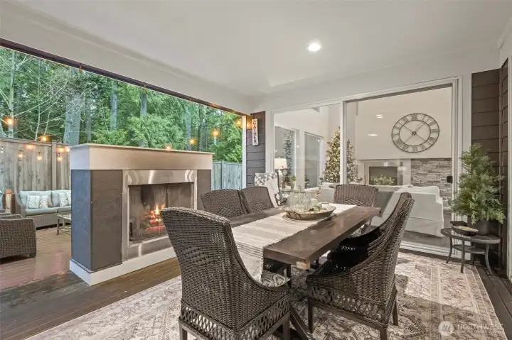 2 Large Sliding Doors Leading to Covered Outdoor Deck with Fireplace
