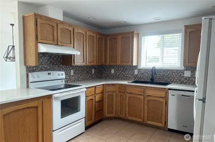 Kitchen with wood cabinets and quartz counter top