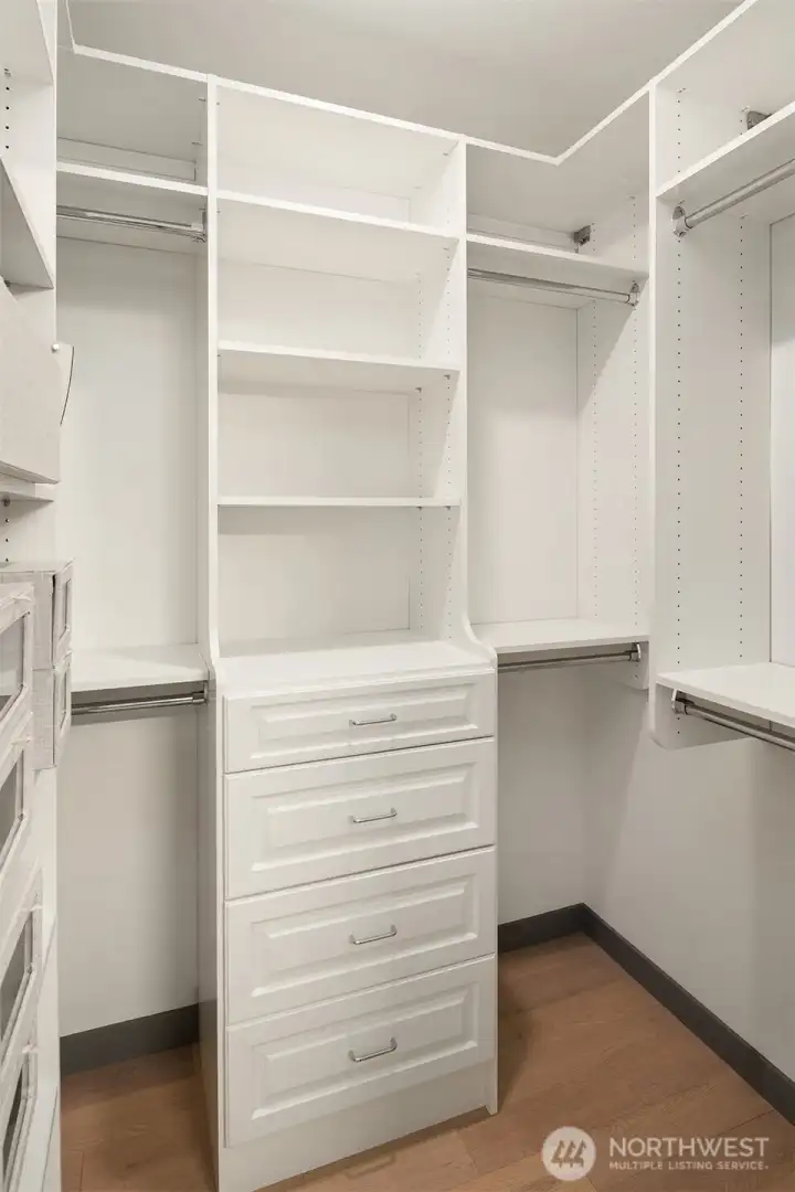 Custom built-ins maximize storage in the walk-in closet.