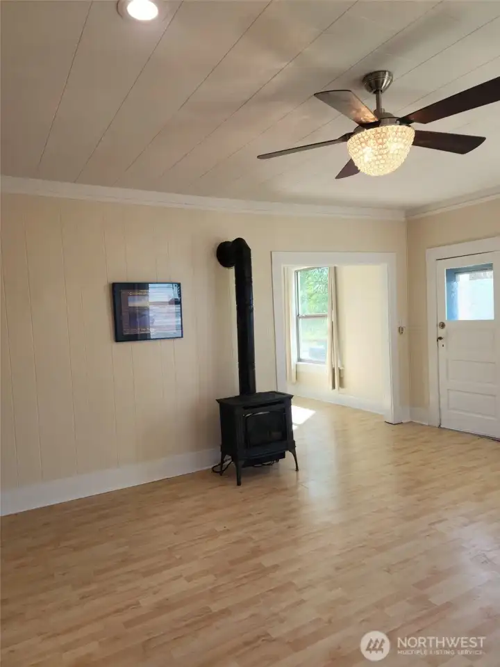 Living room view, shows new fireplace/gas heating unit.