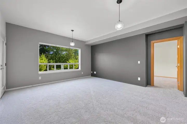 Living room, entrance to one of the 2 primary bedrooms