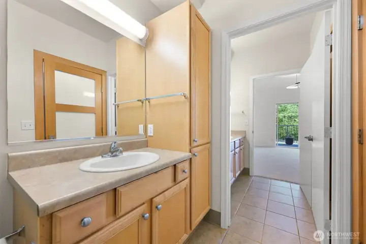 View from #2 primary/main bathroom looking into sink/walk-in closet area and primary bedroom #2