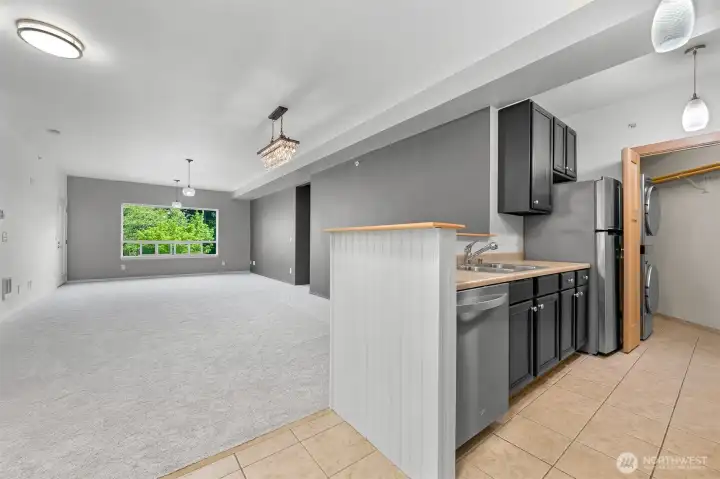 kitchen to the right, then dining room then living room, door to the right in the kitchen leads to tons more storage and newer stackable W/D.