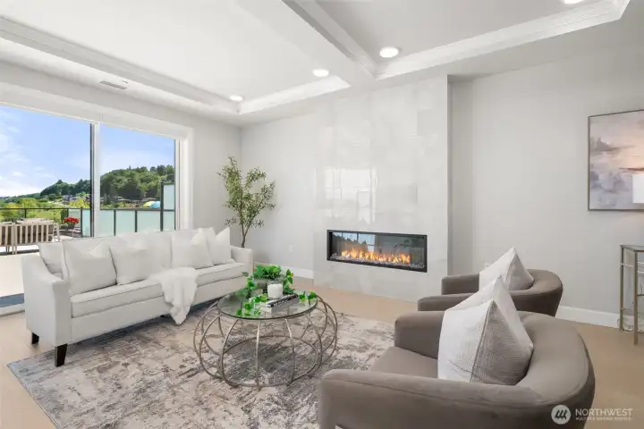 A dramatic linear fireplace serves as a striking focal point, creating warmth and ambiance within this beautifully curated entertaining space. A dramatic linear fireplace serves as a striking focal point, creating warmth and ambiance within this beautifully curated entertaining space.