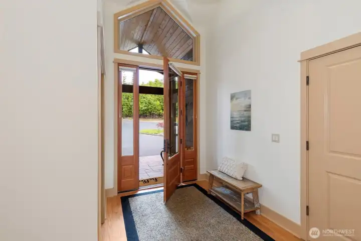 The wide entry features a coat closet and room for a bench or entry table