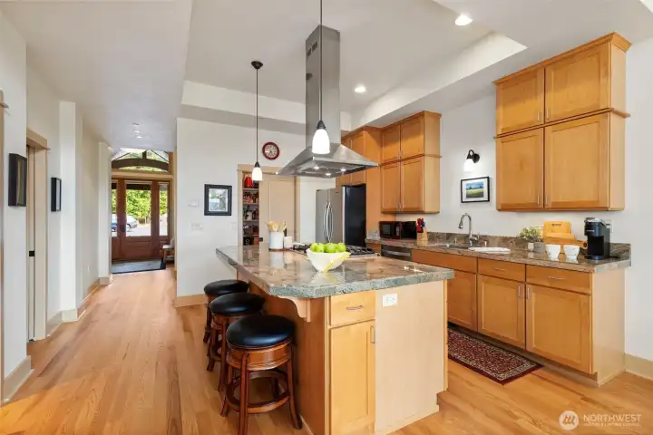 The chefs kitchen has maple cabinets and granite tile counters. The island has space for seating as well as cooking.