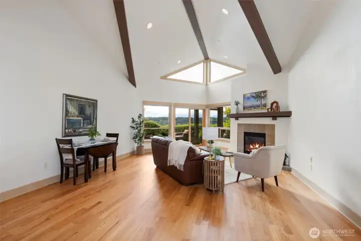 The large great room has beautiful views, vaulted ceilings and a cozy fireplace.