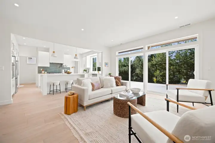 The floor plan is open and the sliding doors bring nature inside and expand the living space to the rear deck. The floor plan is open and the sliding doors bring nature inside and expand the living space to the rear deck.