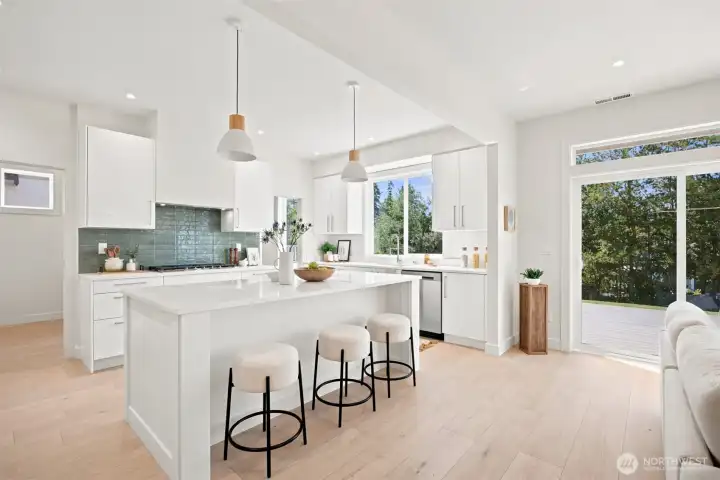 This kitchen is amazing and any chef would enjoy cooking here! There is so much natural sunlight and the tile backsplash above the gas cooktop mimics the salt water views. This kitchen is amazing and any chef would enjoy cooking here! There is so much natural sunlight and the tile backsplash above the gas cooktop mimics the salt water views.
