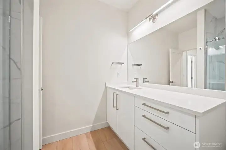 There is a large single-sink vanity at the 3/4 bath on the main floor. There is a large single-sink vanity at the 3/4 bath on the main floor.