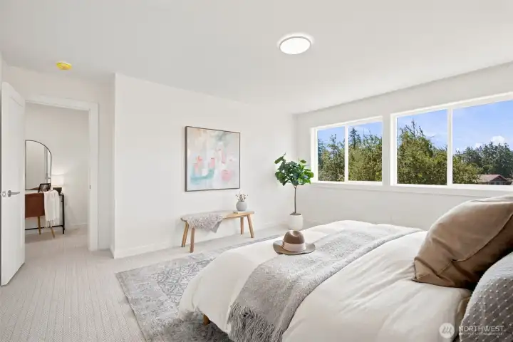 The primary suite is spacious and takes in the bay views. There is a separate dressing area, as well as a stunning full bath and walk-in closet. The primary suite is spacious and takes in the bay views. There is a separate dressing area, as well as a stunning full bath and walk-in closet.