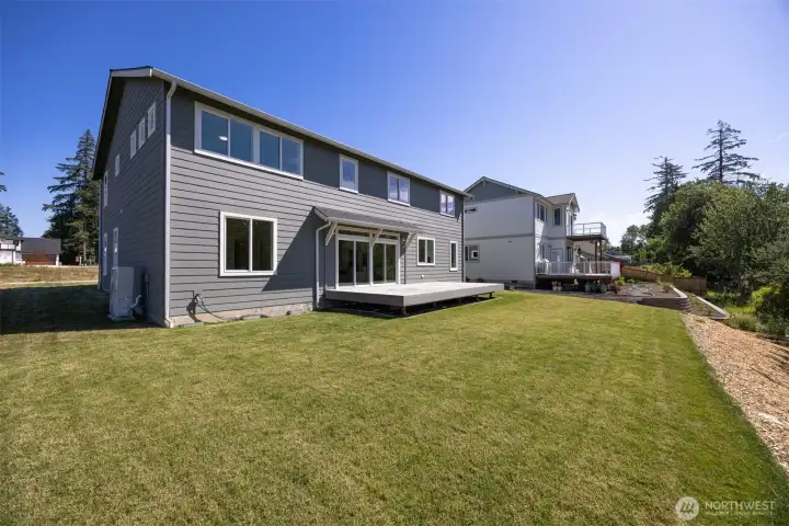 The rear elevation of the home and private lawn. The rear elevation of the home and private lawn.
