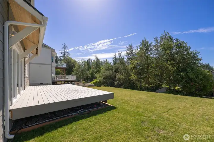 Looking at the spacious and private rear yard and deck. Looking at the spacious and private rear yard and deck.
