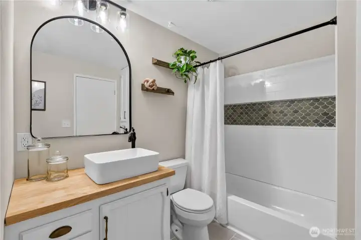 Updated full bathroom with direct access from the primary bedroom features deliberate accents and an elevated feel. Updated full bathroom with direct access from the primary bedroom features deliberate accents and an elevated feel.