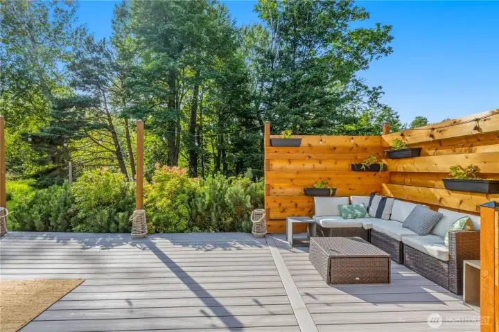 Sip coffee in the morning or unwind in the evening on the cozy outdoor lounge, making this deck an inviting extension of the home's entertaining space. Sip coffee in the morning or unwind in the evening on the cozy outdoor lounge, making this deck an inviting extension of the home's entertaining space.