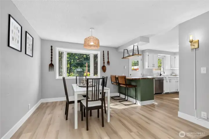 Dining room positioned to capture backyard views through a large picture window, offering a bright setting for everyday meals or entertaining guests. Dining room positioned to capture backyard views through a large picture window, offering a bright setting for everyday meals or entertaining guests.