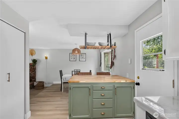 Large butcher block island provides additional prep space, casual seating, and serves as a natural gathering spot adjacent to the dining area. Large butcher block island provides additional prep space, casual seating, and serves as a natural gathering spot adjacent to the dining area.