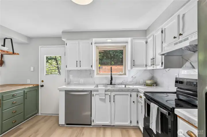 An updated stainless sink and new fixtures , generous counter space, and easy access to the backyard make this kitchen both practical and inviting. An updated stainless sink and new fixtures , generous counter space, and easy access to the backyard make this kitchen both practical and inviting.