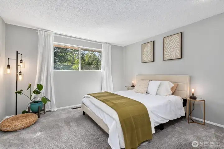 Spacious primary bedroom featuring large windows, neutral finishes, and plenty of room for a king-size furniture arrangement. Spacious primary bedroom featuring large windows, neutral finishes, and plenty of room for a king-size furniture arrangement.