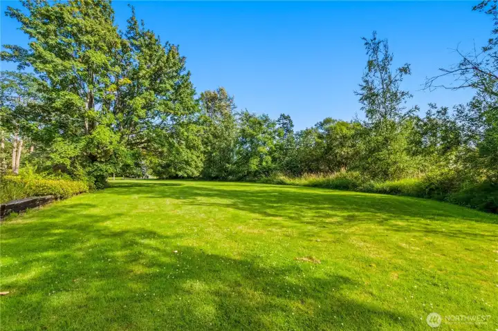 Expansive lawn and mature landscaping create a peaceful setting with room for outdoor recreation, gardening, or simply enjoying the privacy of this oversized homesite. Expansive lawn and mature landscaping create a peaceful setting with room for outdoor recreation, gardening, or simply enjoying the privacy of this oversized homesite.