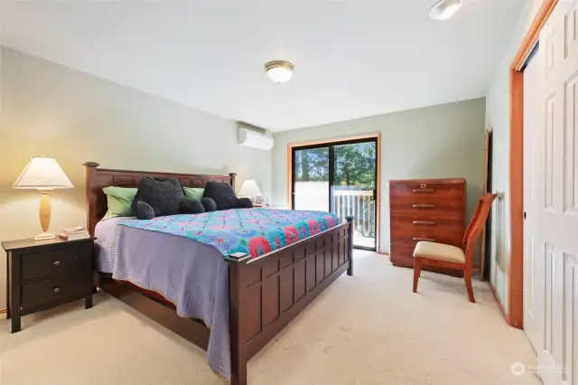 Primary Bedroom. Sliding glass door leads to deck with view of lake & overlooking back yard.