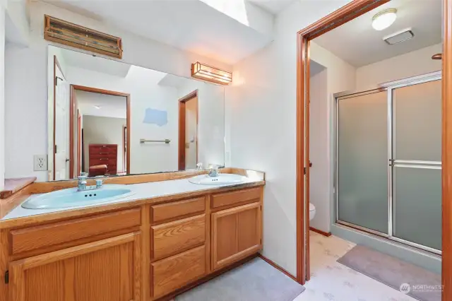 Primary Bathroom with double sink vanity. Pocket door provides privacy to shower & toilet.