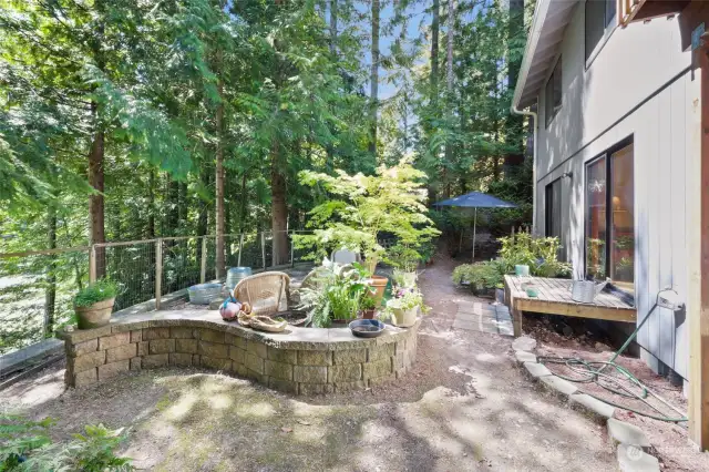 Backyard recent retaining wall added, pathway leading down to water.