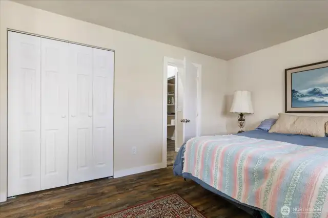 Bedroom closet and door to bathroom.