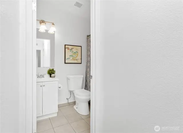 Full bath off main hall; new light fixture and faucets.