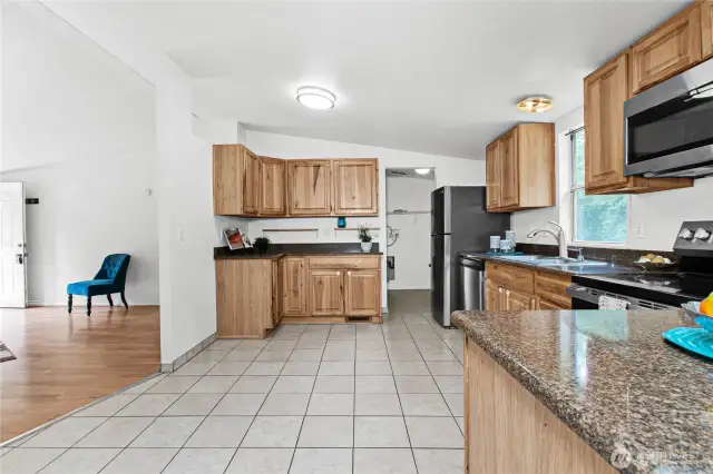 Utility room and back door is straight ahead through kitchen. That is where washer/dryer would be placed and water heater is there as well.  The home is all-electric.